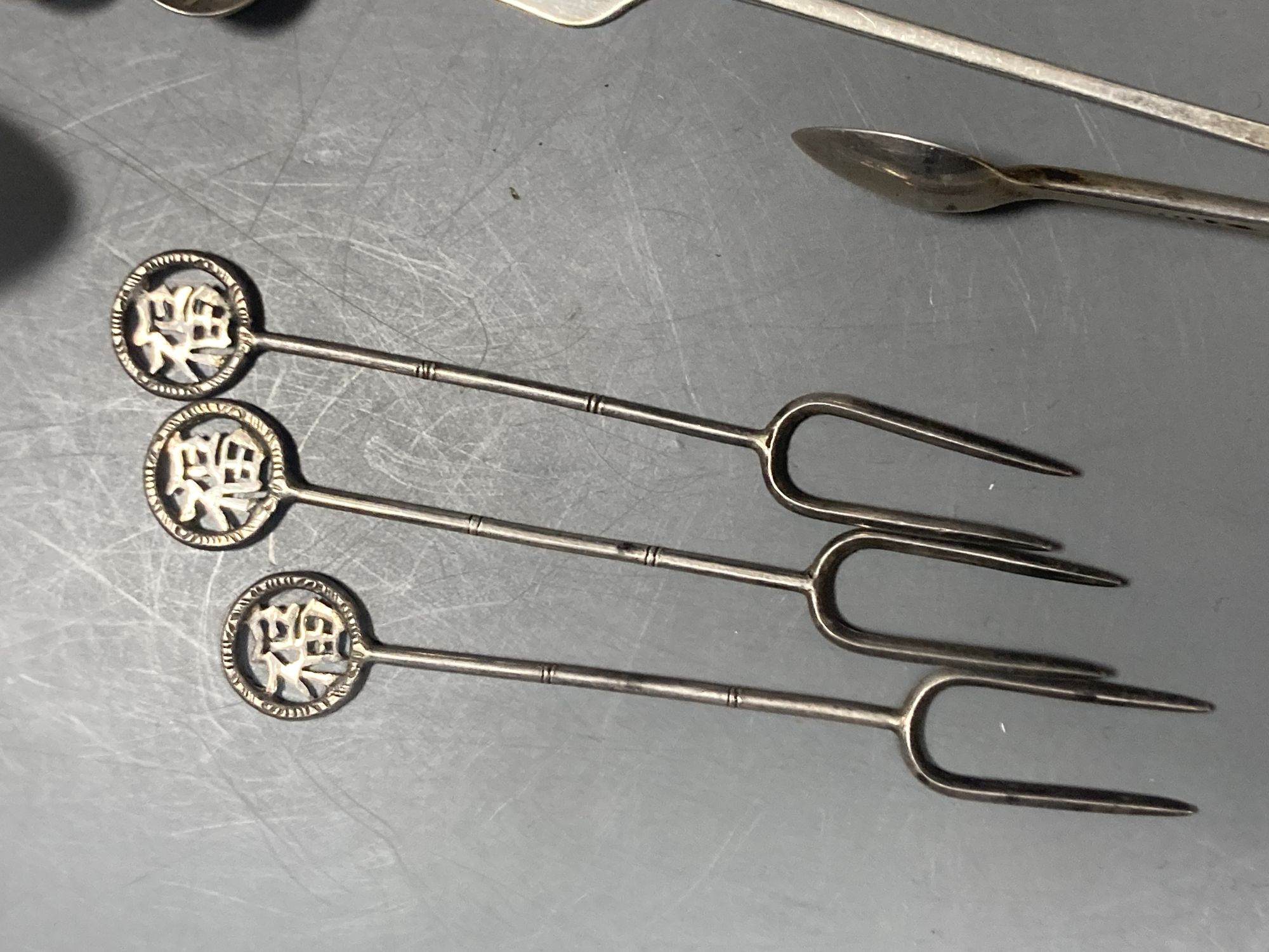 A group of assorted Chinese white metal spoons and forks, including set of six teaspoons and ten small items of English silver.